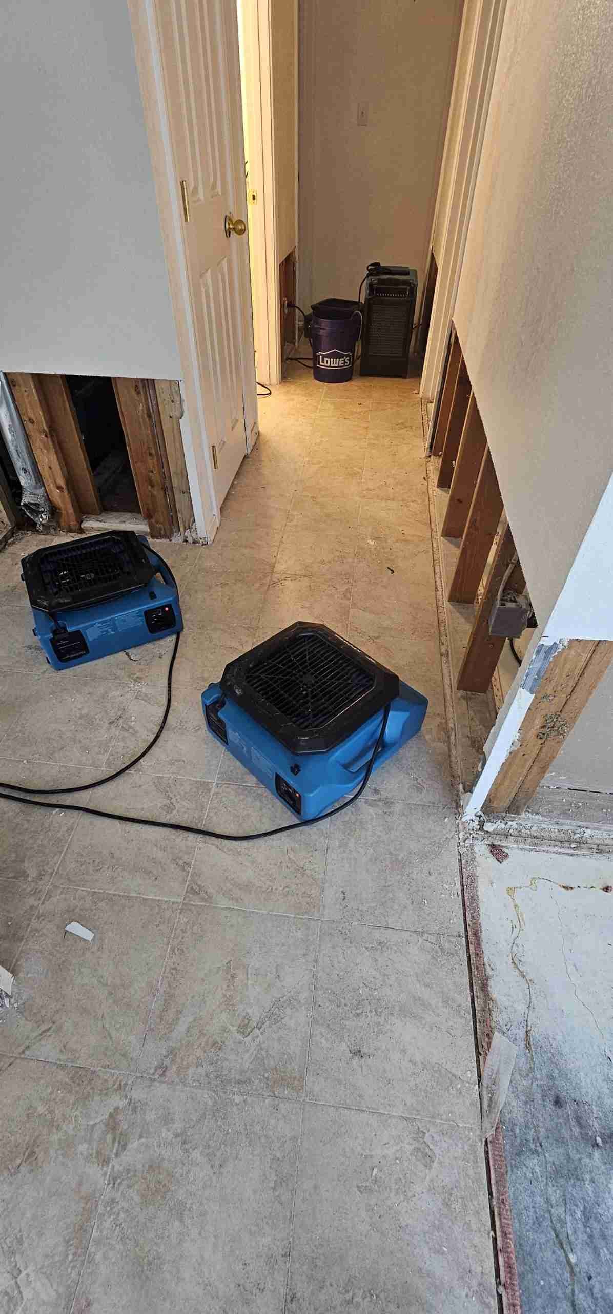 Water Damage Restoration 27 Water damage demolition and structural drying area with air movers operating during mitigation